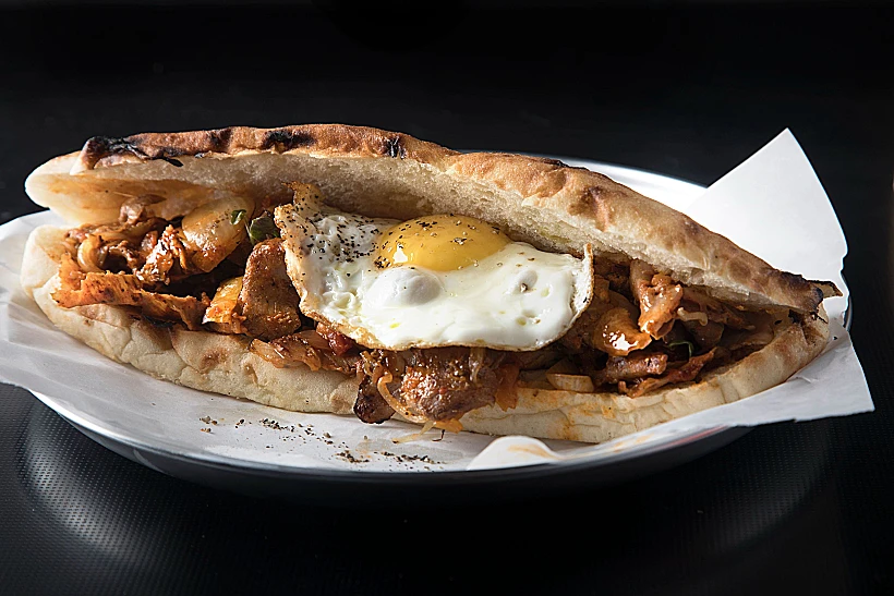 שווארמה מוקפצת עם רוטב שקשוקה ואז מוגשת עם ביצת עין. השקשוקה של שווארמקס