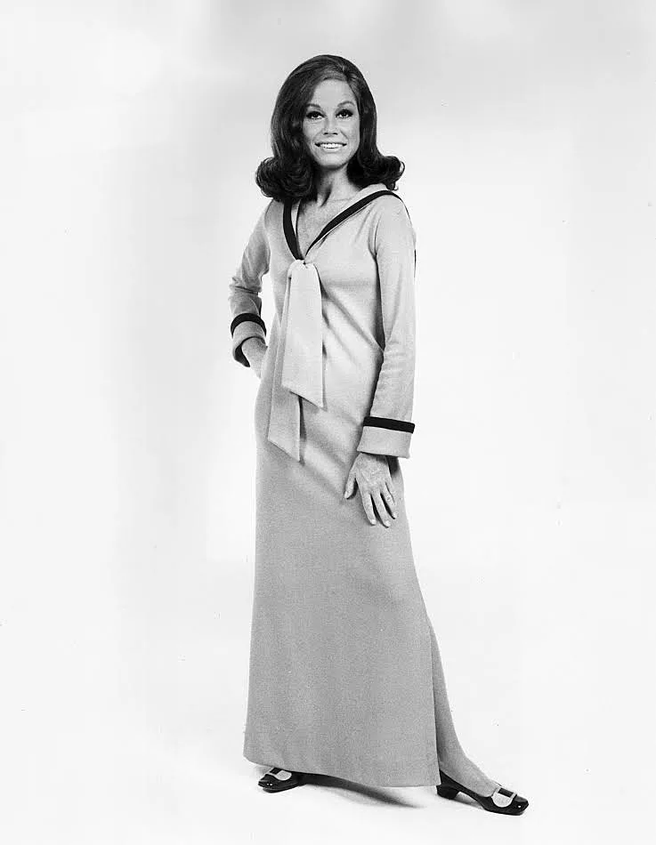 1974: Full-length studio portrait of American actor Mary Tyler Moore. She is wearing a long sleeved, full-length dress which