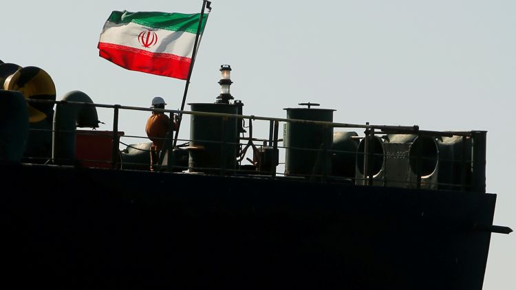 A Crew Member Raises The Iranian Flag On Iranian Oil Tanker Adrian Darya 1, Previously Named Grace 1, As It Sits Anchored After The Supreme Court Of The British Territory Lifted Its Detention Order, In The Strait Of Gibraltar