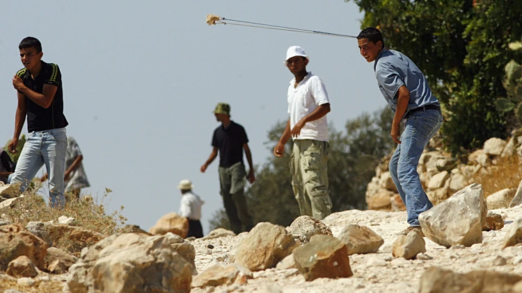 פלסטינים זורקים אבנים ליד רמאללה