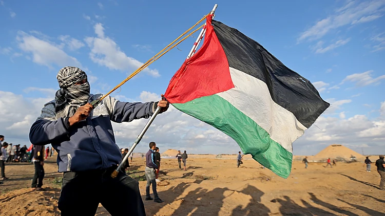 Palestinian Demonstrator Uses A Sling During An Anti Israel Protest In The Southern Gaza Strip