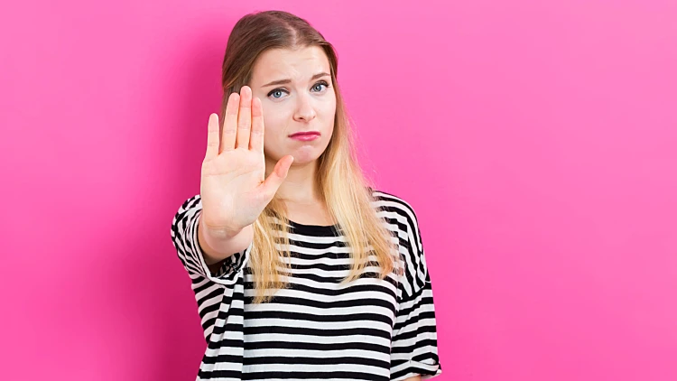 Young Woman Making A Stop Pose On A Pink Background