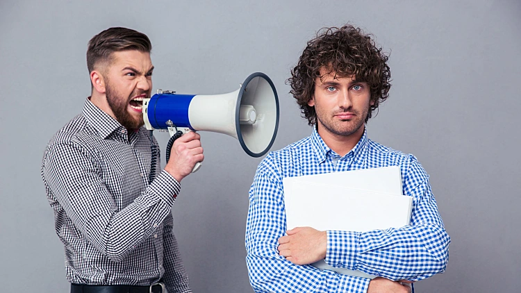 Businessman Screaming Via Megaphone To Another Man