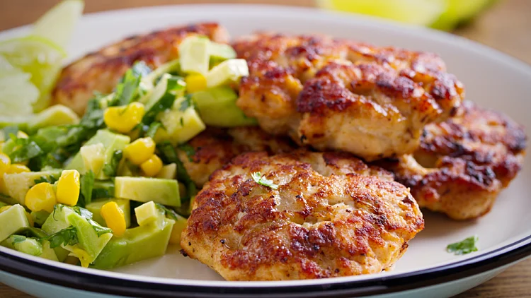 Homemade,chicken,patties,or,burgers,with,avocado,corn,salsa.,horizontal
