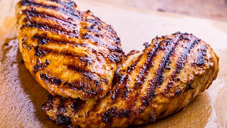 Grilled,chicken,breast,in,different,variations,on,a,wooden,board.