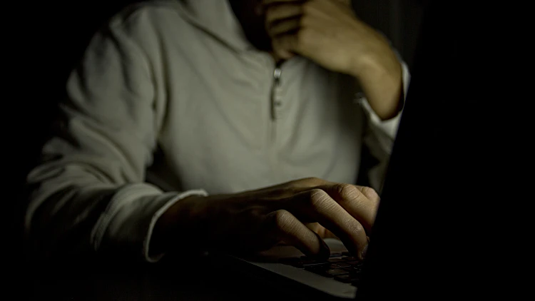 Anonymous,male,on,a,laptop,at,night.,concept,of,internet