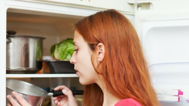 Red Haired Woman Looking For Something In Fridge