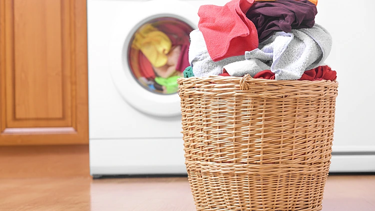 Laundry,basket,on,the,background,of,the,washing,machine.