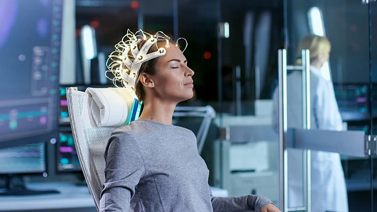 Woman,wearing,brainwave,scanning,headset,sits,in,a,chair,while