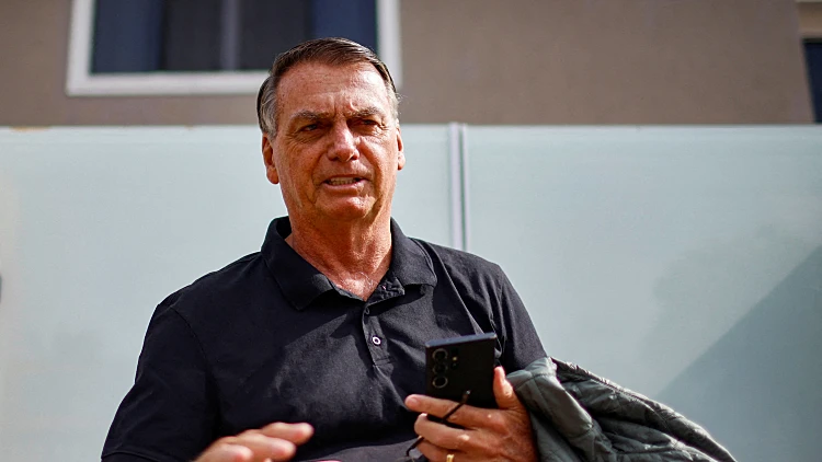 File Photo: Former Brazilian President Jair Bolsonaro Gestures While Standing In Front Of His House Before Testifying To The Federal Police In Brasilia
