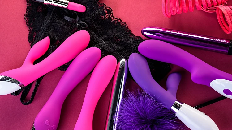 Different,adult,sex,toys,on,a,pink,background,with,black