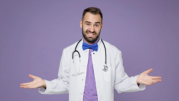 Confused,puzzled,young,bearded,doctor,man,wearing,white,medical,gown