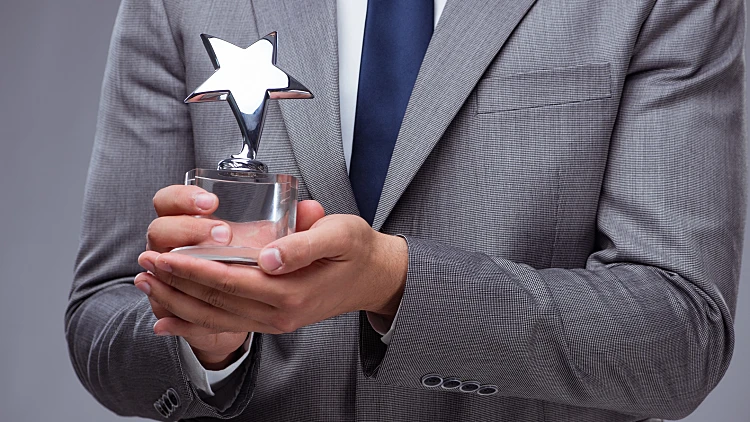 Businessman,holding,star,award,in,business,concept