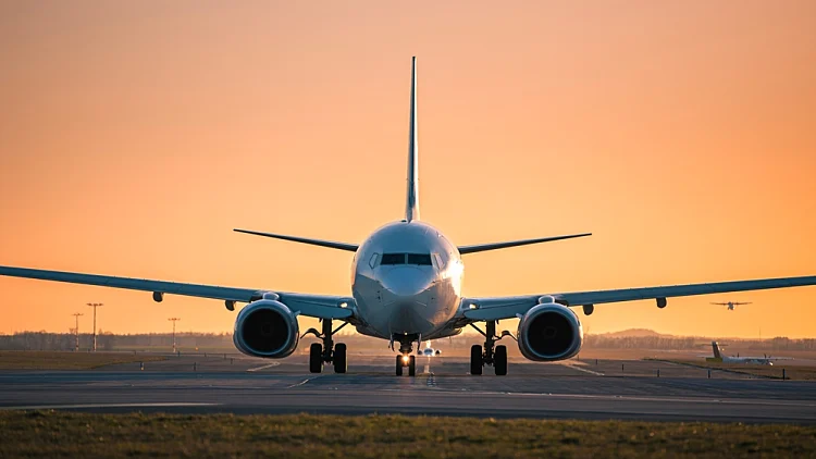 Traffic,at,airport,at,golden,sunset.,front,view,of,taxiing