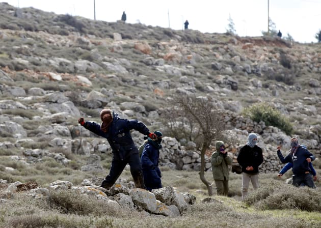 נערים מיידים אבנים על כוחות הביטחון במהלך פינוי עמונה