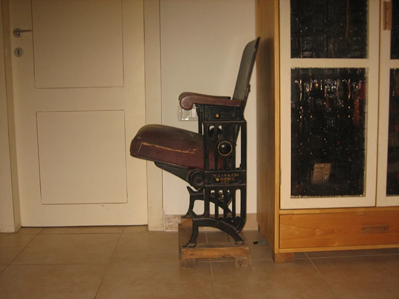 כסא קולנוע עתיק מעור, עץ ופיתוחי ברזל בבית משפחת גל