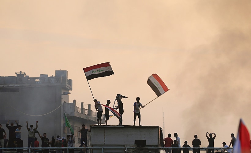 Demonstrators Hold Iraqi Flags As They Take Part In A Protest Over Unemployment, Corruption And Poor Public Services, In Baghdad