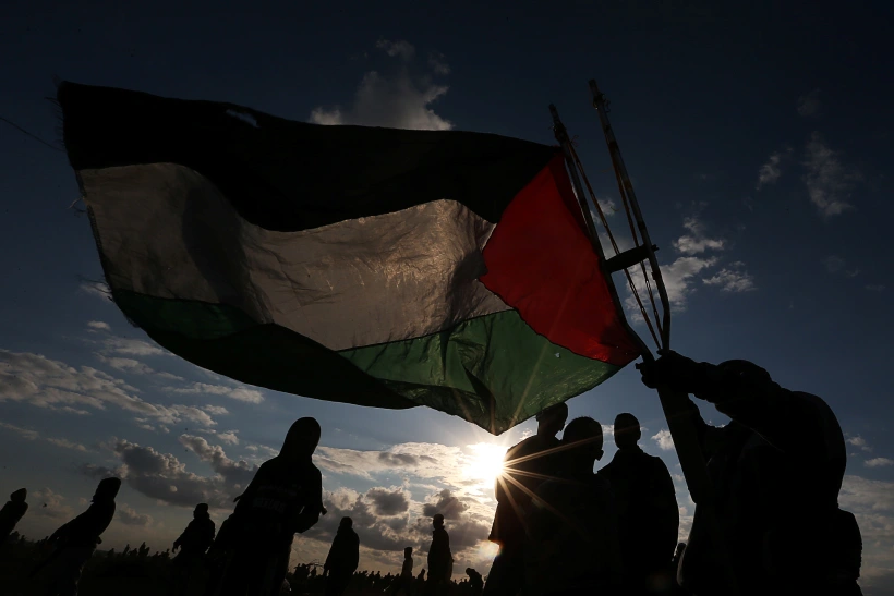Demonstrator Waves A Palestinian Flag During An Anti Israel Protest In The Southern Gaza Strip