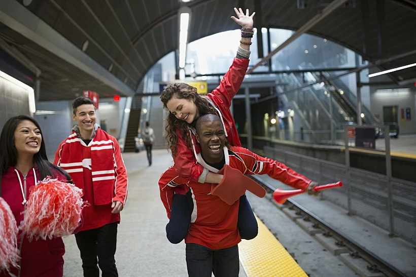 Enthusiastic Sports Fans Red Cheering Subway Station Platform