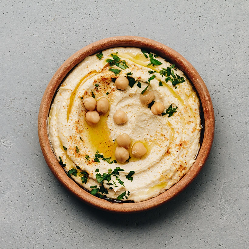Large,bowl,of,homemade,hummus,garnished,with,chickpeas,,red,sweet