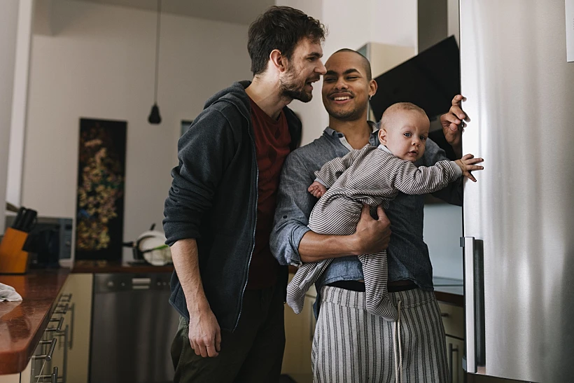 Smiling Gay Men With Baby