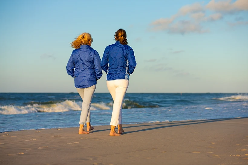 Two,middle Aged,women,walking,on,beach