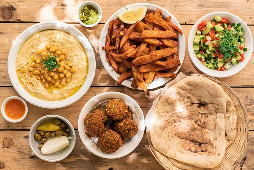 Israel,traditional,food,hummus,with,chickpea,and,parsley,,vegetarian,falafel,