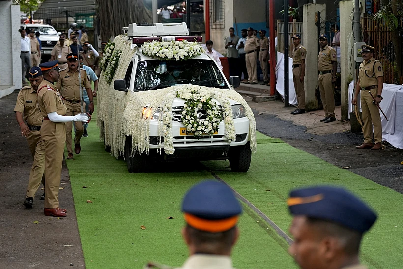 A Hearse Van Carrying The Body Of Former Chairman Of Tata Group Ratan Tata, Moves Past Police Officers On The Day Of His Funeral In Mumbai