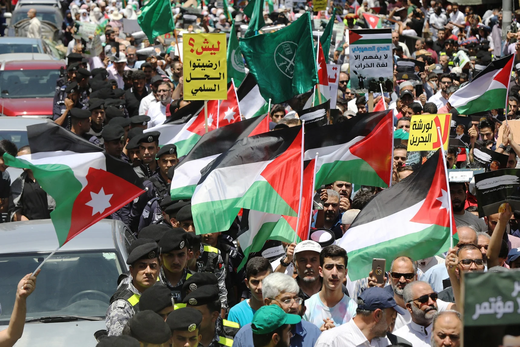 Jordanian Protesters Hold Jordanian And Palestinian Flags As They Chant Slogans During A Protest Against U.s. President Donald Trump's ''deal Of The Century'' In Amman