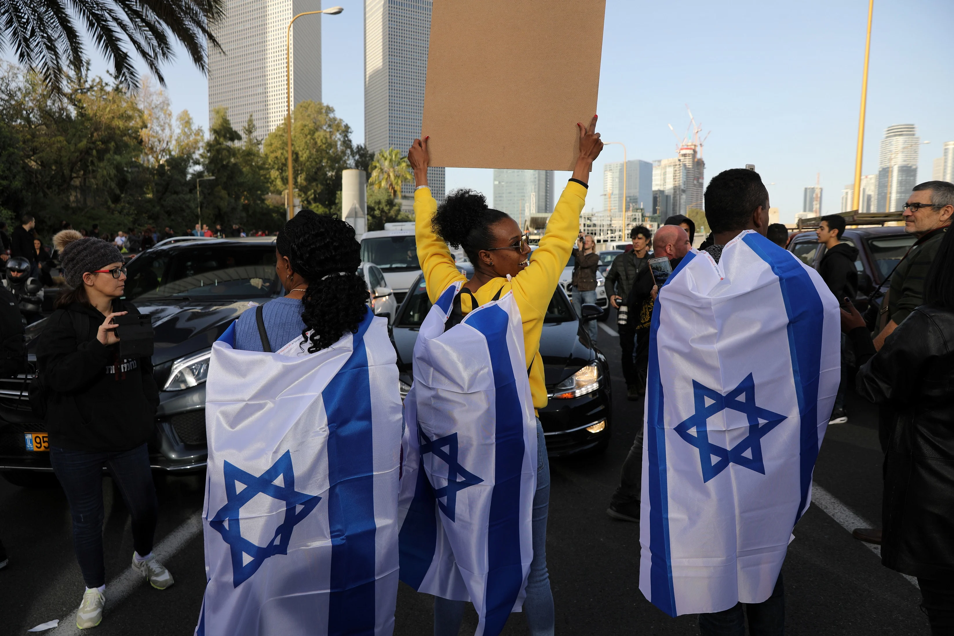Israelis Of Ethiopian Decent Cover Themselves With Israeli Flags As They Take Part In A Demonstration Against Police Brutality, Following The Death Of An Israeli Ethiopian Community Member, Yehuda Biadga, In Tel Aviv, Israel