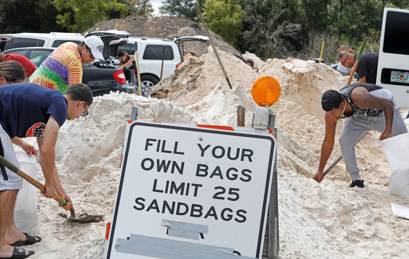 תושבים מקומיים ממלאים שקיות חול כדי להגן על בתיהם לקראת בואו של ההוריקן דוריאן לפלורידה, ארה''ב
