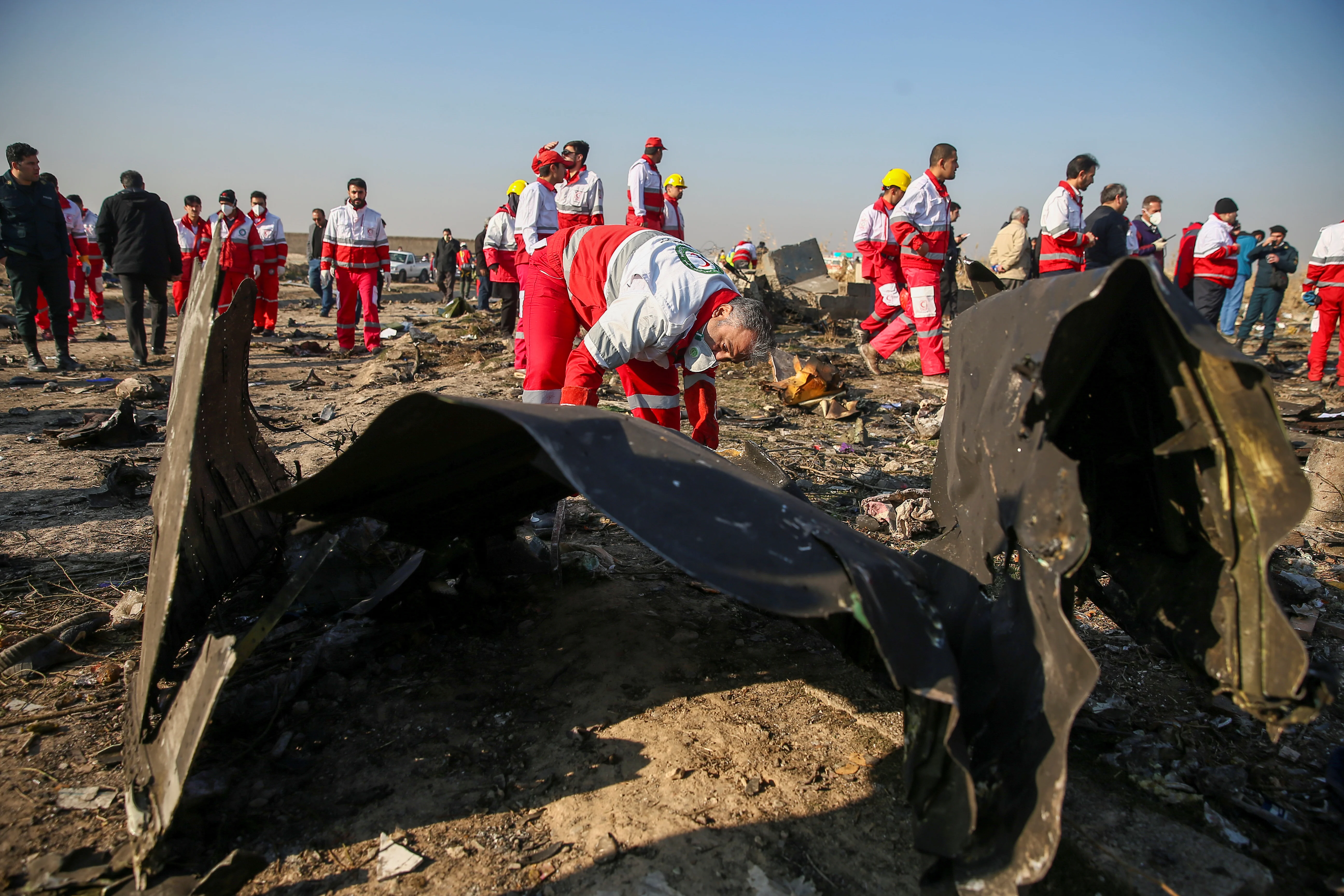 Red Crescent Workers Check The Debris From The Ukraine International Airlines Plane, That Crashed After Take Off From Iran's Imam Khomeini Airport, On The Outskirts Of Tehran