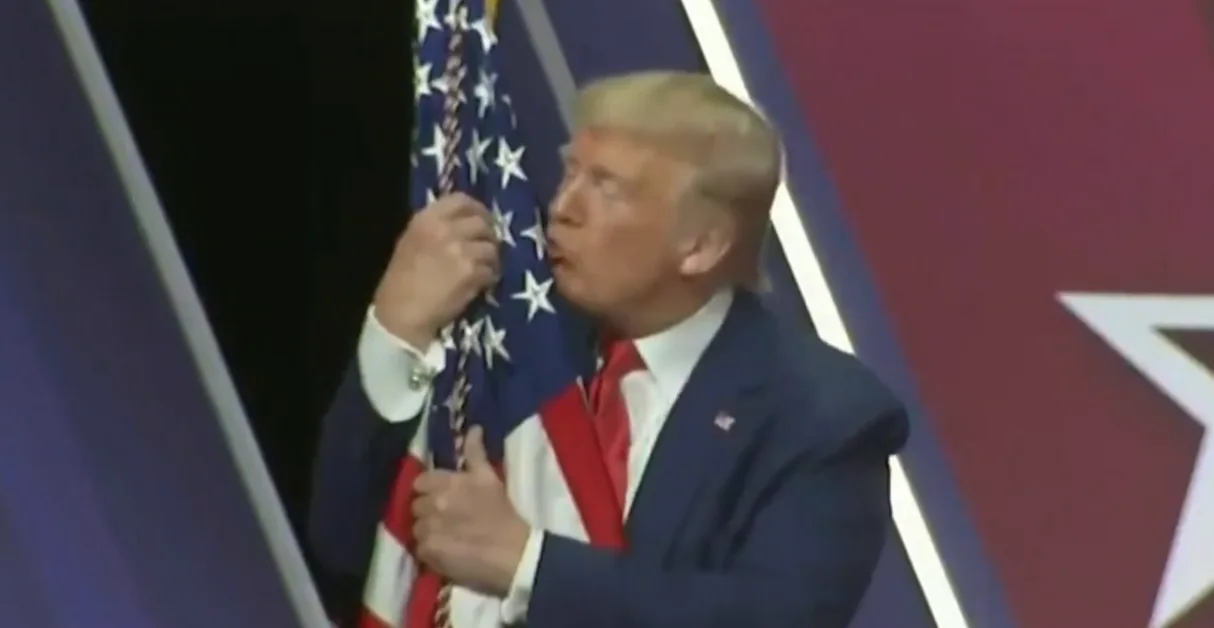 נשיא ארצות הברית דונלד טראמפ מנשק את דגל המדינה