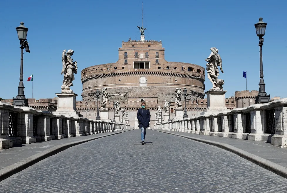 אישה הולכת עם מסיכת פנים ברומא בעקבות נגיף