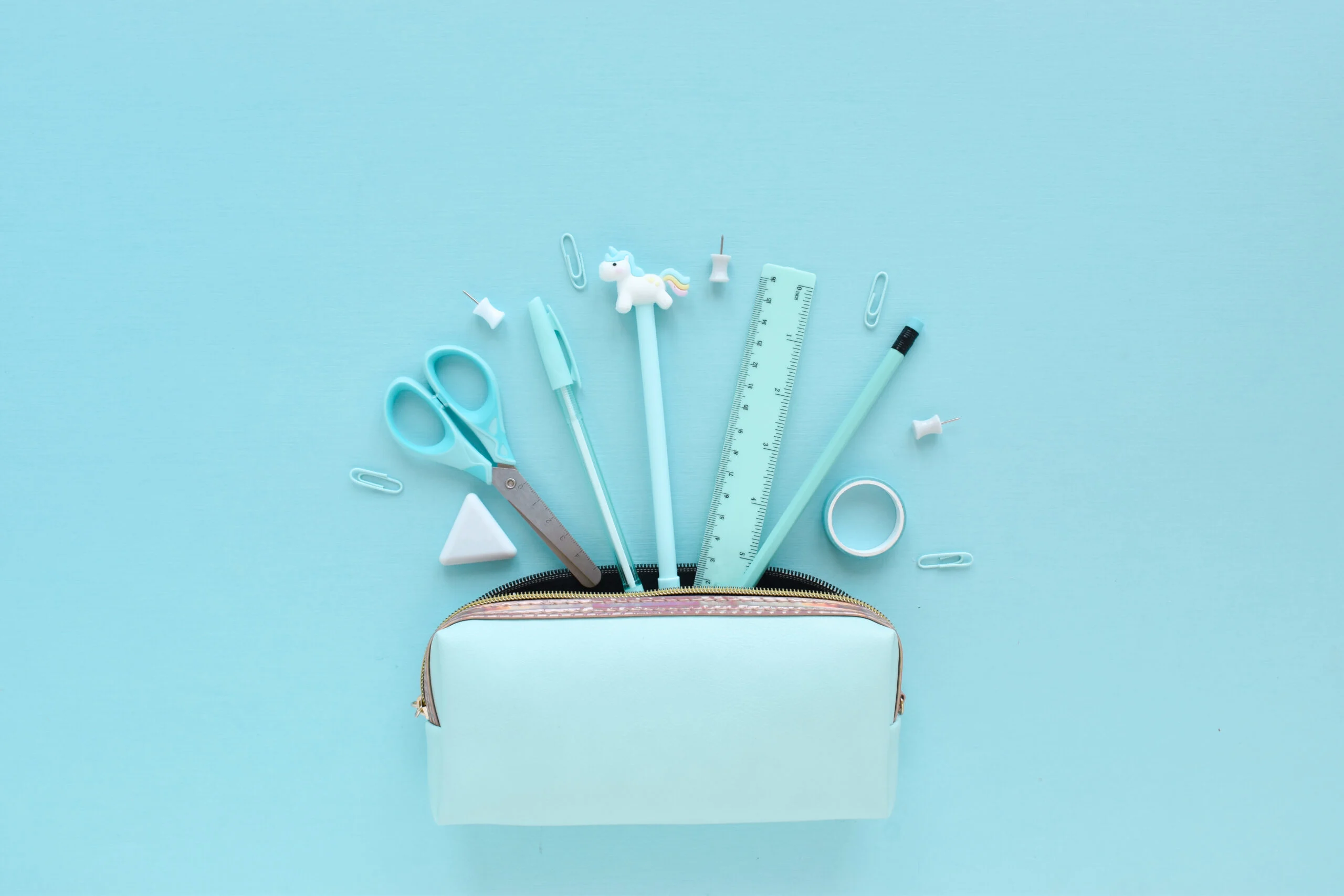 Light Blue Pencil Case With Stationery On A Light Pastel Background. Flat Lay