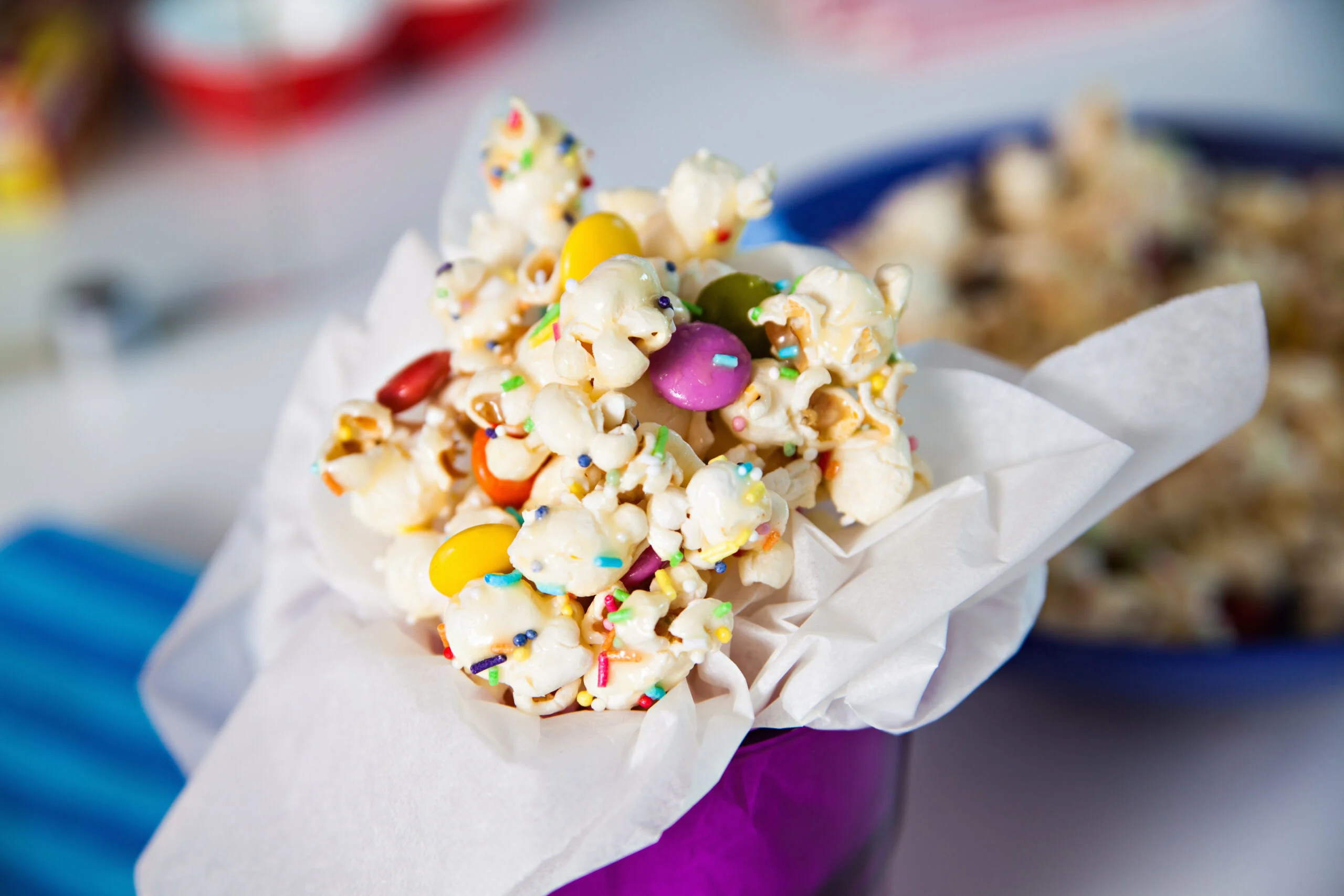 Glass,cup,full,of,sweet,popcorn,with,candies,and,sprinkles