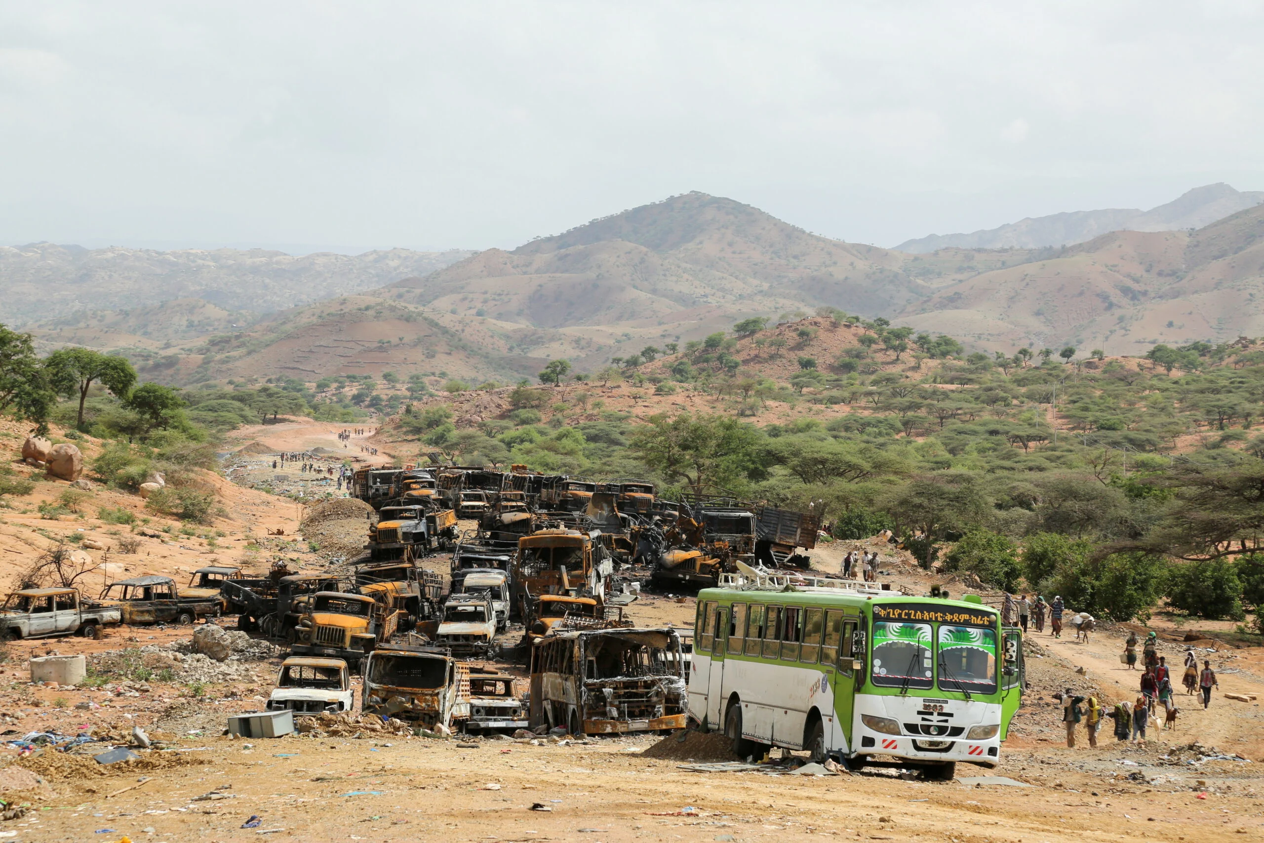File Photo: Villagers Return From A Market To Yechila Town In South Central Tigray Walking Past Scores Of Burned Vehicles, In Tigray
