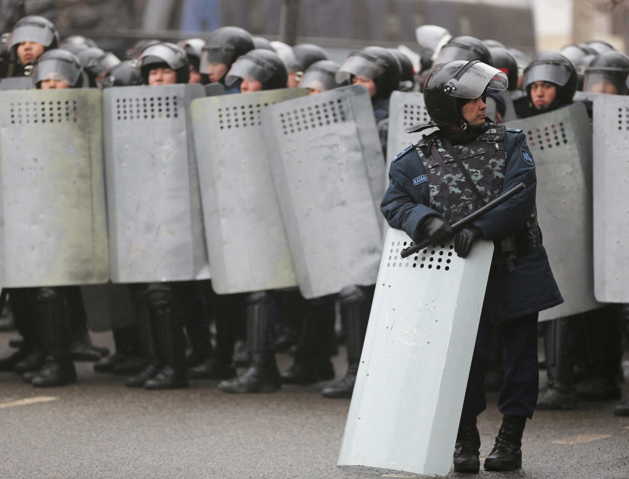 Kazakh Law Enforcement Officers Block A Street During A Protest Triggered By Fuel Price Increase In Almaty