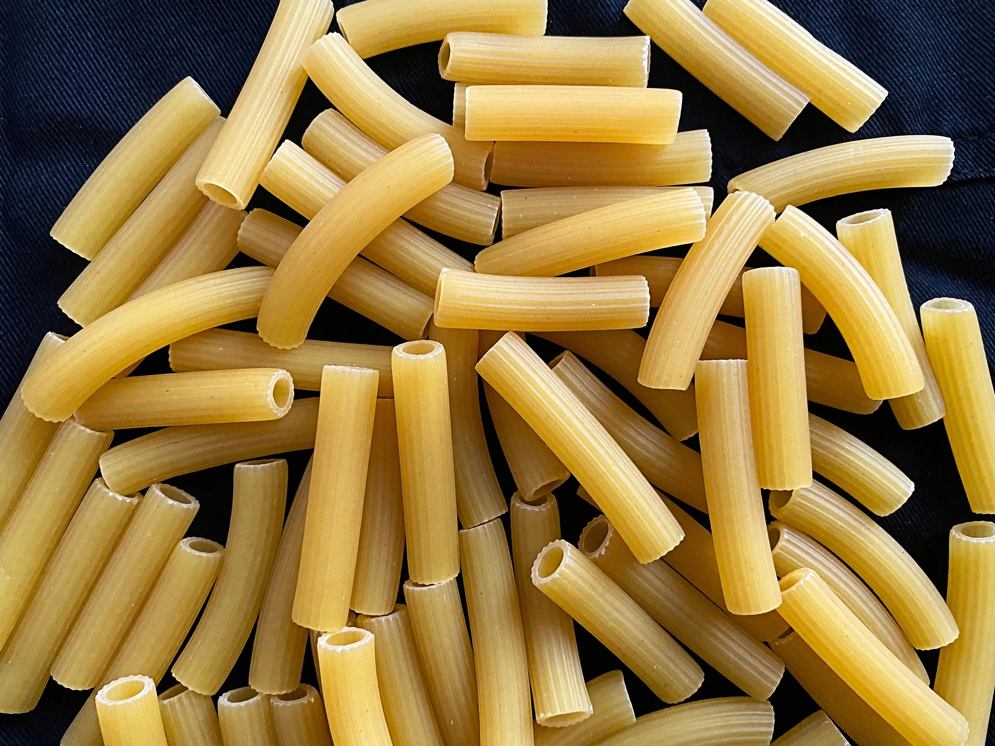 Raw,italian,maccheroni.,italian,traditional,pasta,on,dark,background.,close Up