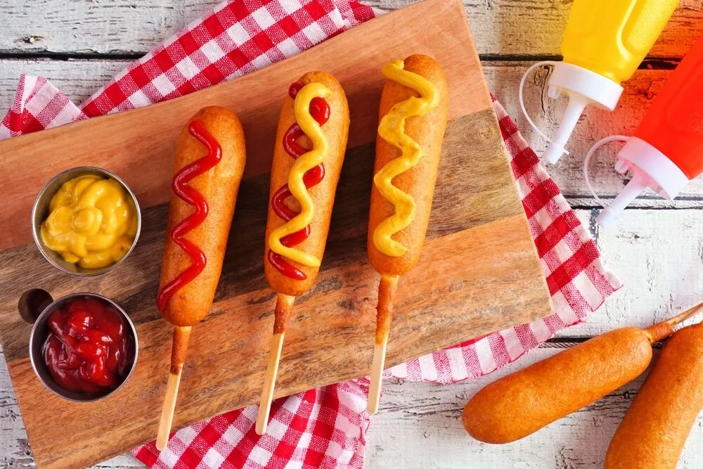 Corn,dogs,with,mustard,and,ketchup.,top,view,table,scene