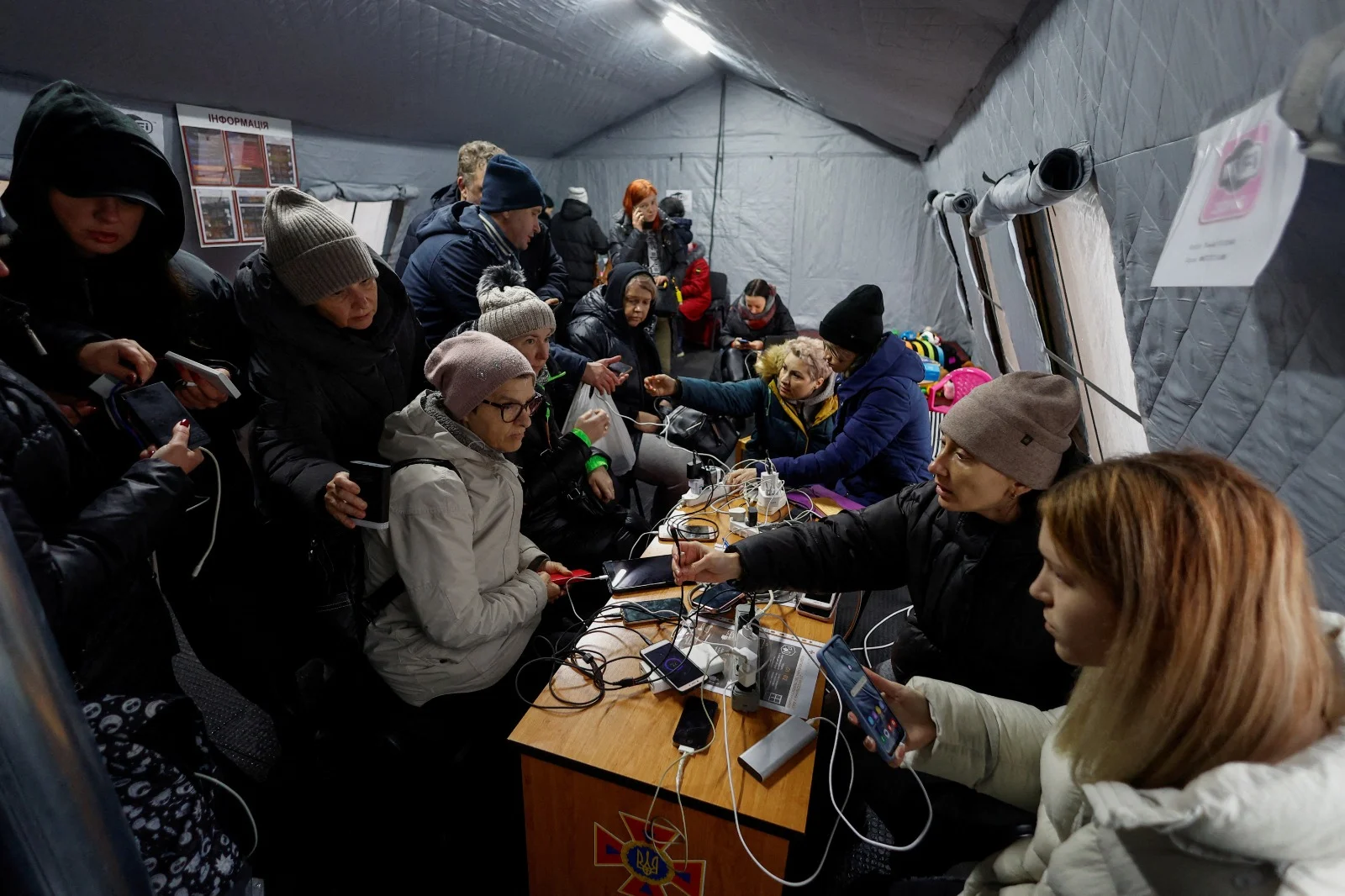 אזרחים בקייב מטעינים טלפונים ניידים באוהל חירום, הפסקת חשמל ברחבי המדינה בעקבות התקיפה הרוסית