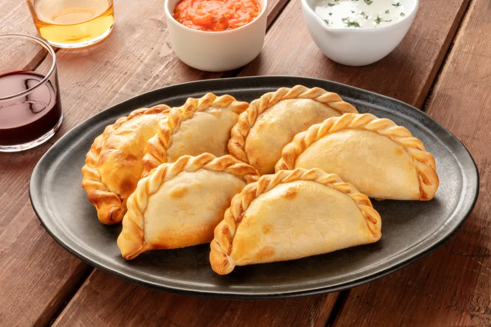 A,closeup,of,argentinian,empanadas,with,sauces,and,wine,on