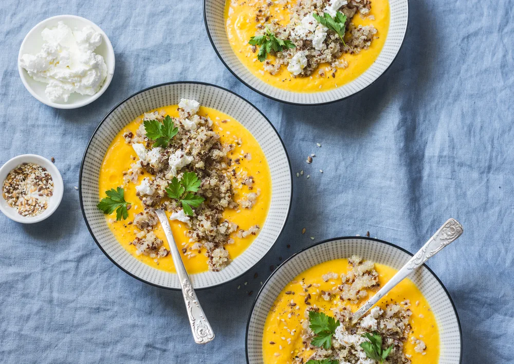 Fall,pumpkin,soup,with,quinoa,and,feta,cheese,on,a