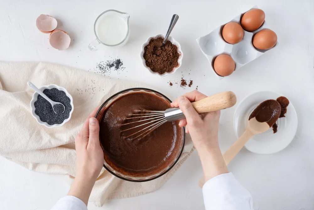 The,process,of,making,a,chocolate,cake.,female,hands,stir