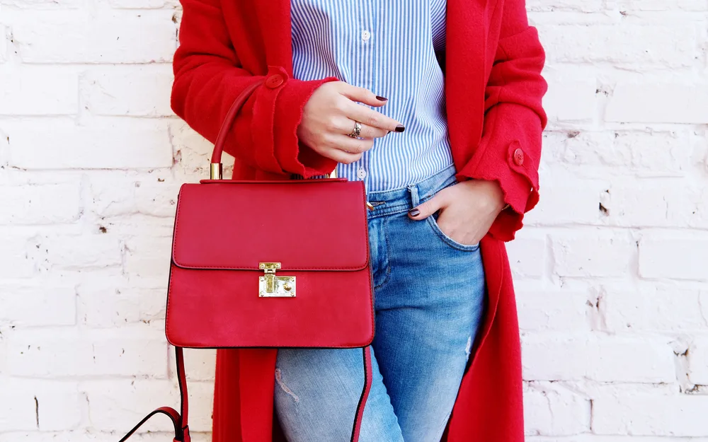 Closeup,of,red,small,bag,in,hand,of,woman.,fall