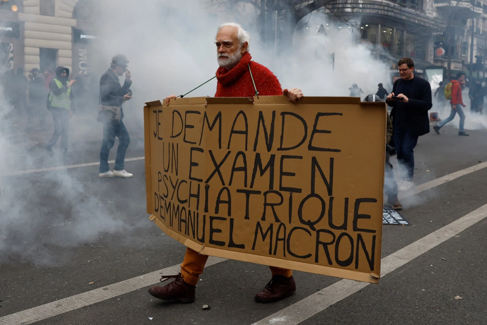 מפגין בפריז עם השלט האומר ''אני דורש שעמנואל מקרון יעבור בדיקה פסיכיאטרית''